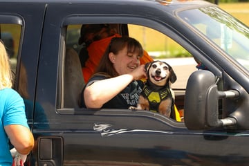 dog and owner at shelter drive thru