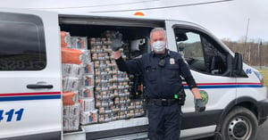 police officer distributing pet food