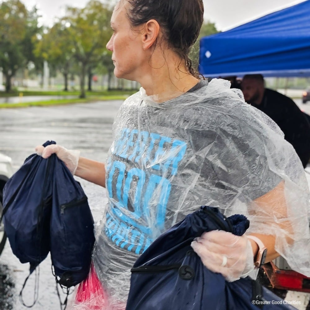 Volunteer handing out emergency packs during Hurricane Helene