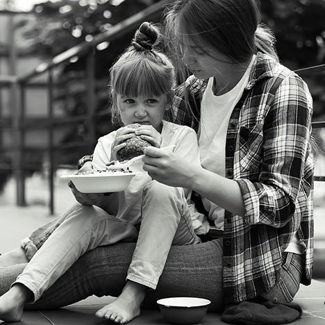 poor-people-eating-donated-food-on-street-black-and-white