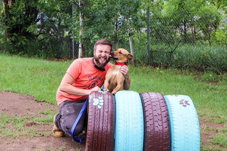 Rescue Rebuild - photo of Zac and a puppy at a renovation